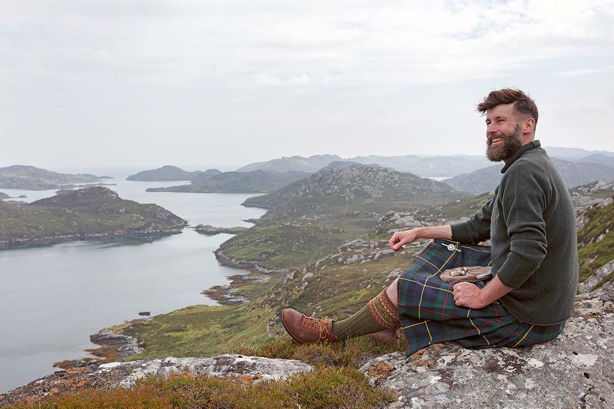 the hebridean baker coinneach macleod from the isle of Lewis stands on a hilltop on Lewis