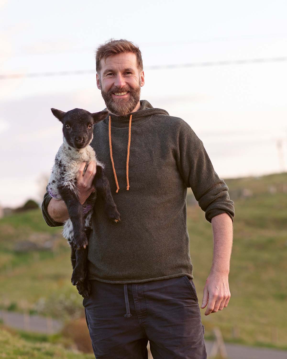 coinneach macleod on the isle of lewis holding a lamb