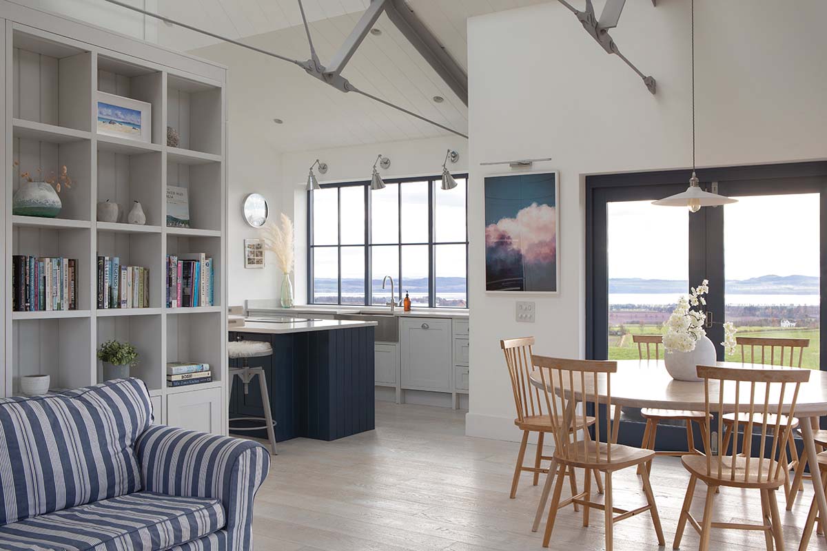 living area with patio doors leading to patio are with views of scottish countryside 