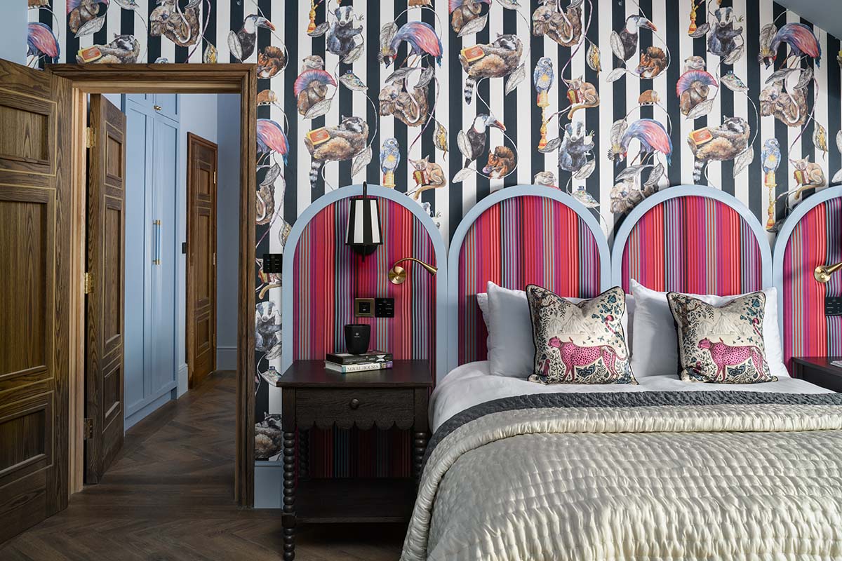 bedroom in the tempus hotel with impressive headboards and patterned walls