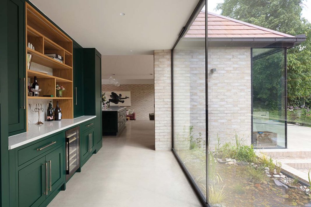 jane perfect interiors transforms this arts and crafts build in morningside in edinburgh - this is a photograph of the hallway and extensions which is lined with floor to ceiling windows and shot by Susie Lowe