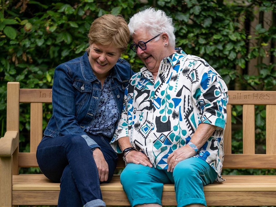 In the Company of Books with Val Mcdermaid and Nicola Sturgeon - the pair laugh on a bench