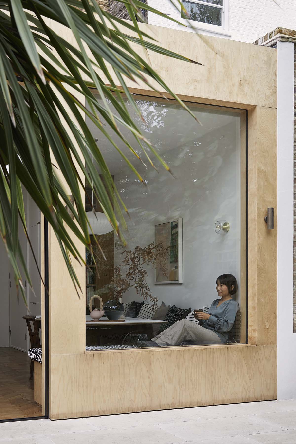 patio area with floor to ceiling windows and a conservatory box that transformed an old extension - easy renovation ideas for inner city living