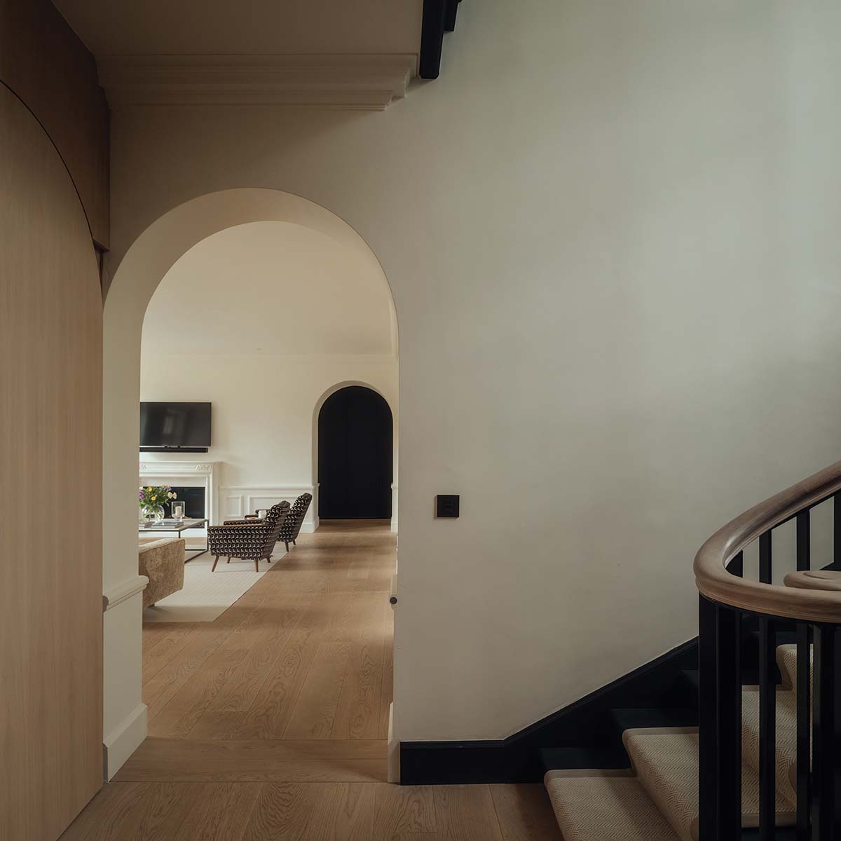 The original timber staircase was refreshed with a coat of black paint. The iron balusters had to be replaced, but the refurbished wooden handrail is original - redesign in barnton edinburgh