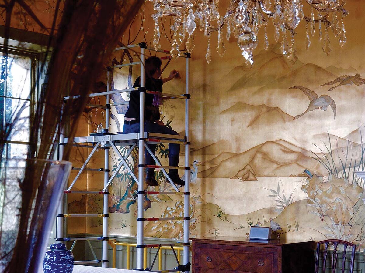 The pair often have to climb scaffolding for their larger murals. This is the gilded dining room with the Japanese and Scottish inspired illustrations