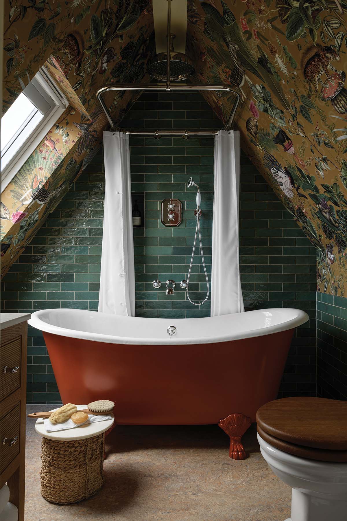 impressive bathroom with red bath, green tiled walls and wallpaper roof in elegant florals in a revamped Edinburgh house