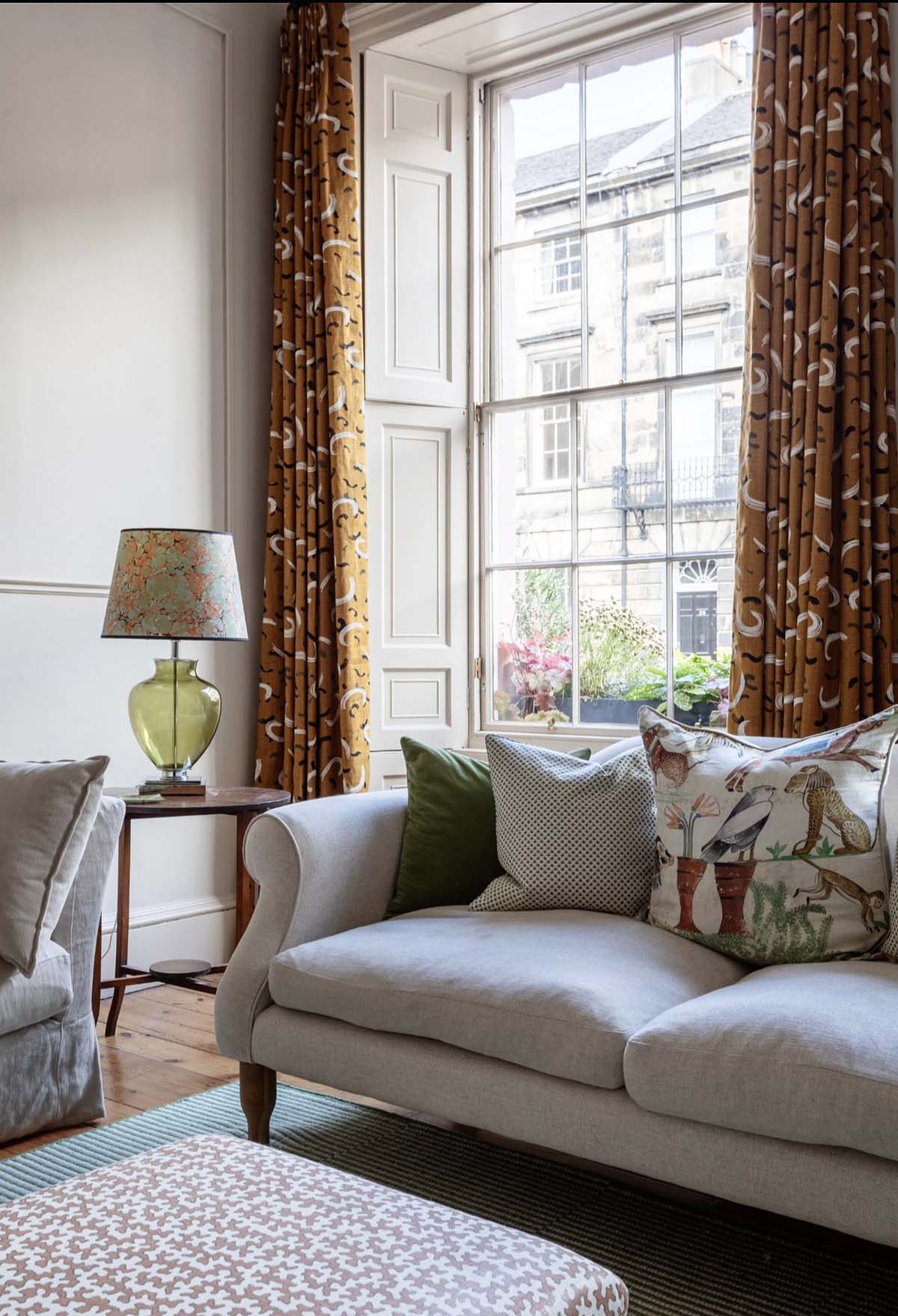 interior of a new georgian townhouse designed by studio strachan - patterned curtains with an elegant footstool and two seater sofa