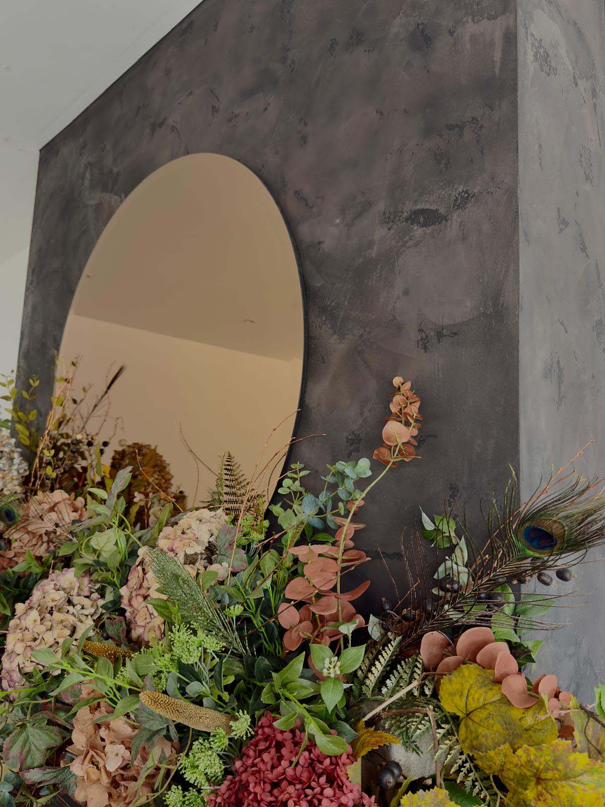 venetian plaster walls in a Scottish home with circle mirror and flowers