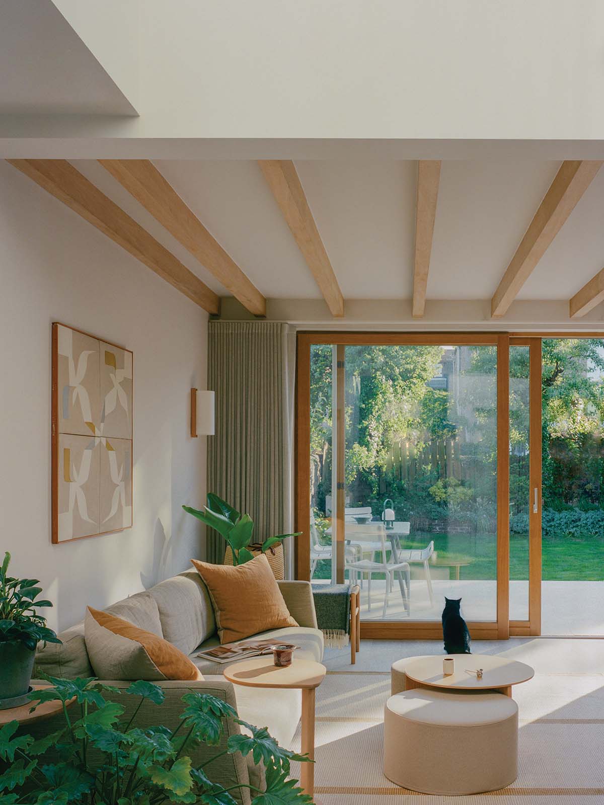 living room with patio doors and wooden overhead beams in a two-storey home in edinburgh