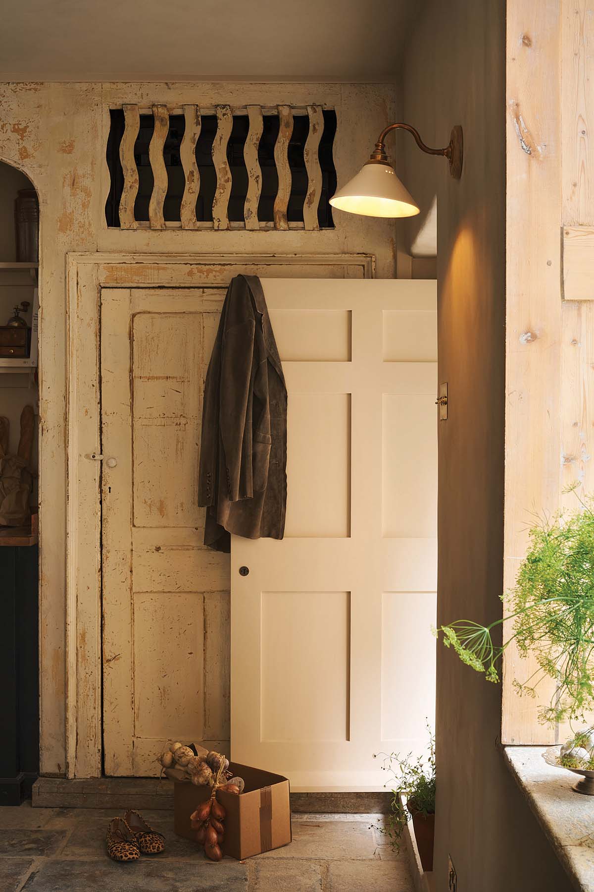 bath townhouse kitchen designed by banjoy beale with exposed stone walls, aga cooker, large dining table in dark wood and inset sink