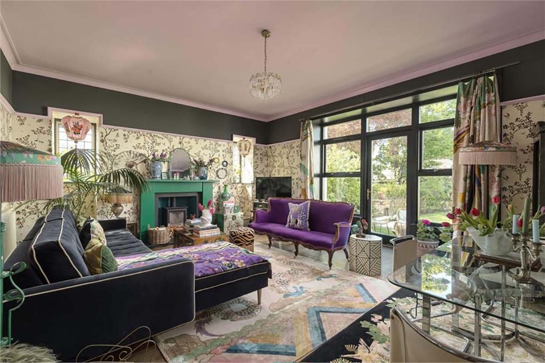 living room with purple couch, mural walls, floral motifs designed by wendy mirosson
