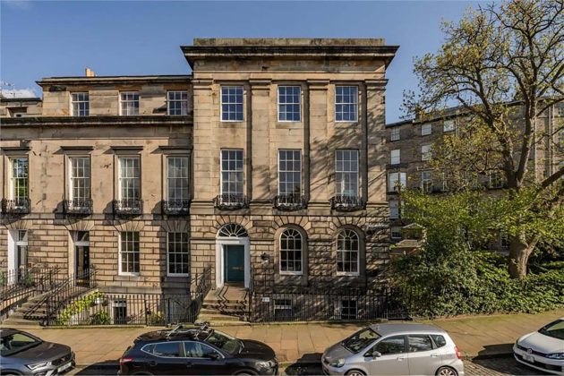 high-end homes for sale in Edinburgh; old tenement flats in edinburgh with trees and cars on the street as well as arched windows and iron fencing