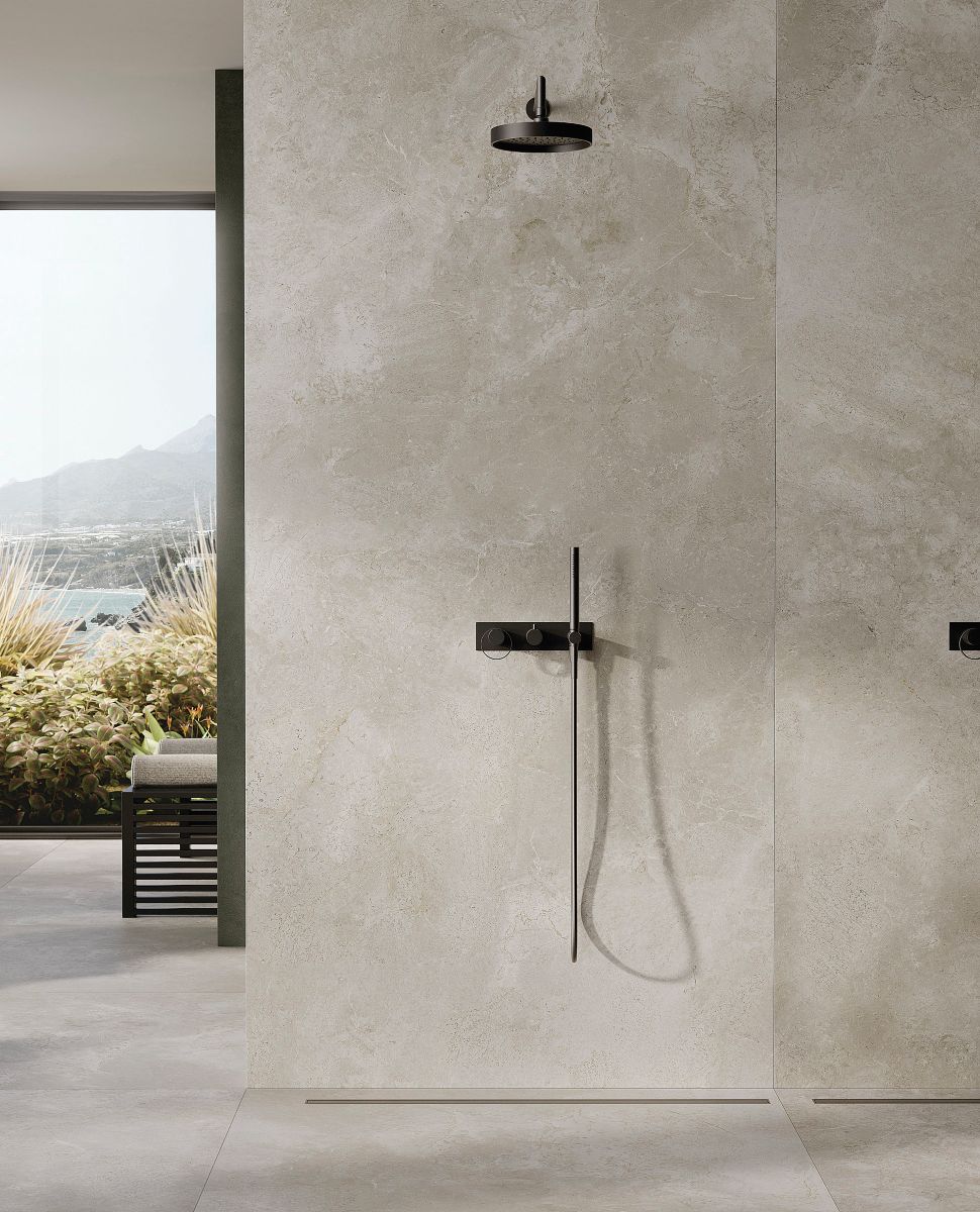 stone bathroom with black shower and benches