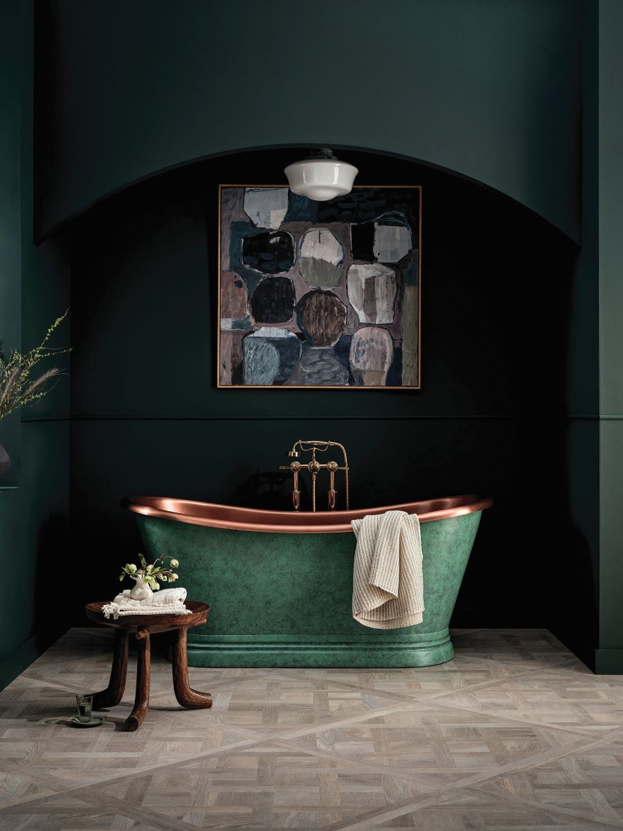 a bathroom decorating idea is coloured bath and dark walls