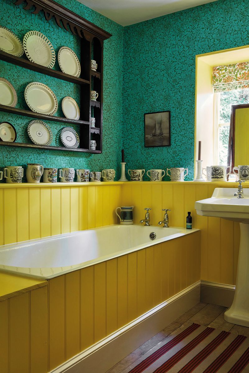bathroom decorating ideas include bright colours, yellow bath panels, striped flooring and a patterned wallpaper