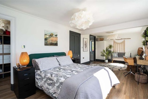 high-end homes for sale in Orchard Wood; primary bedroom with green headboard wooden floors, absract lampshades and green doors in a house for sale in scotland with espc