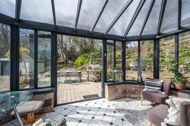 high-end homes for sale in Orchard Wood; conservatory with black beams, frosted glass roof and black and white floor tiles in a house for sale in scotland with espc