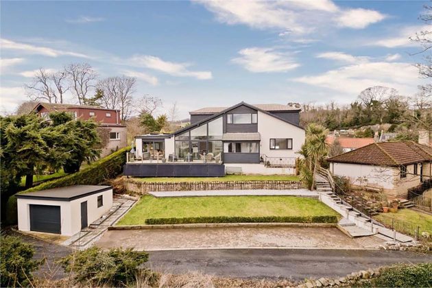 high-end homes for sale in Tanglewood; exterior of a grey and white multi-level house in scotland worth nearly one million pounds