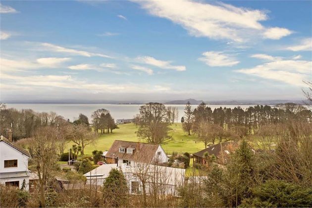 high-end homes for sale in Tanglewood; seaside views from a home in scotland with brown trees and green fields