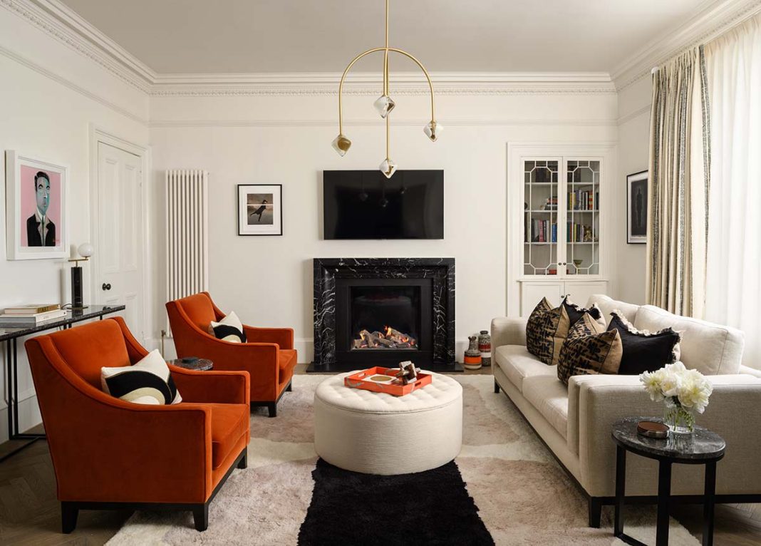 white-room-black-fireplace-red-armchairs-grey-sofa-modern-chandelir