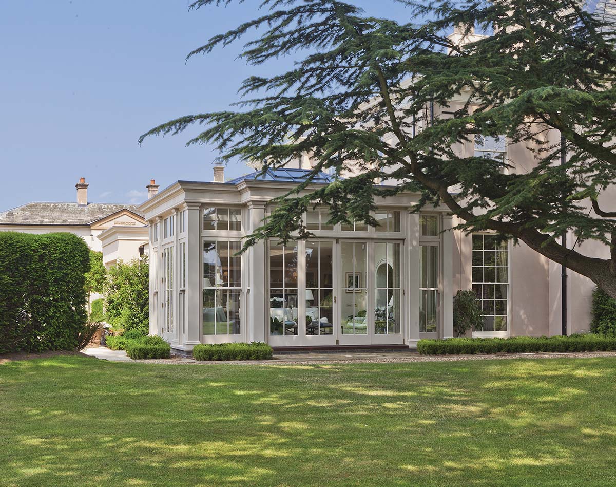 big white conservatory, white conservatory in an old georgian house with green grass and a big tree
