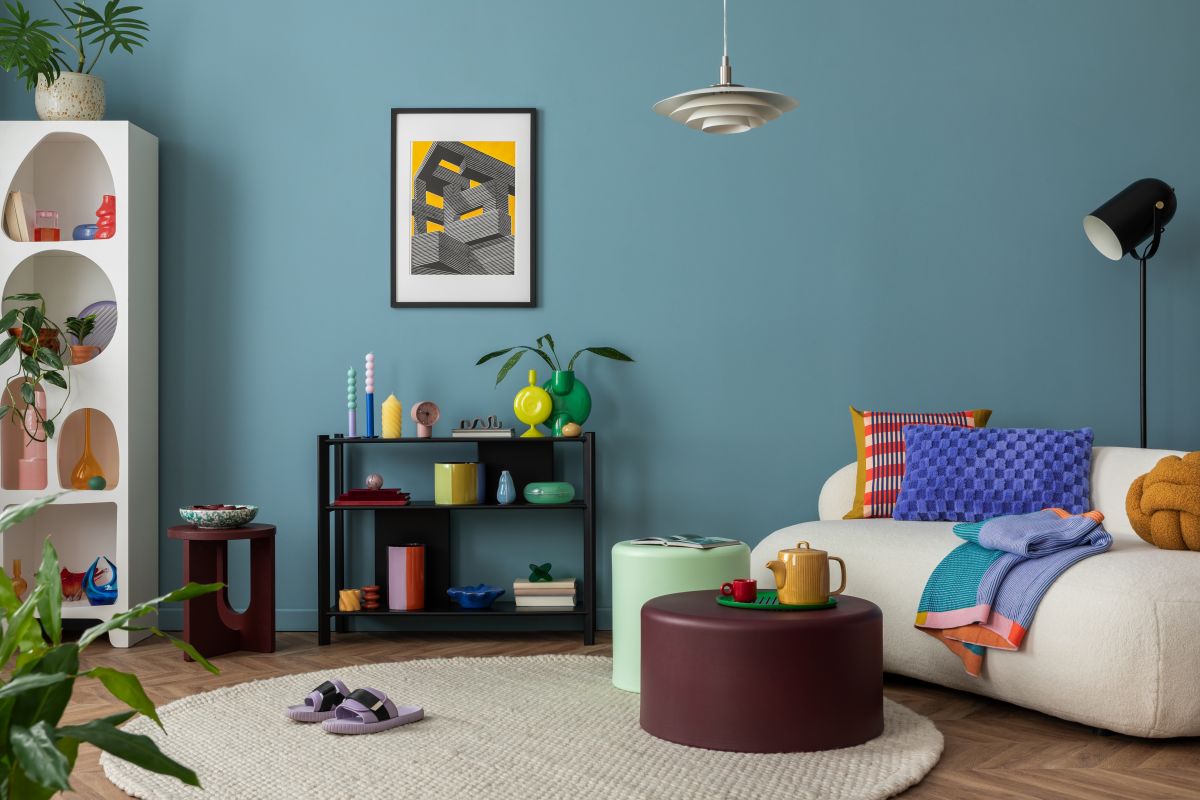 multi-coloured creative living room with urban outfitters home furniture and pastel blue sofa cushions