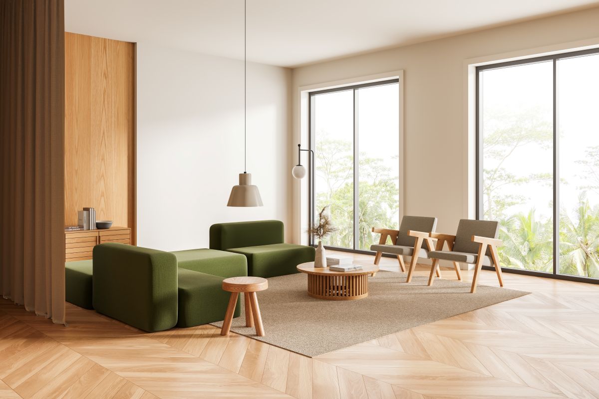 minimalist japandi interior with window walls, a green sofa and rattan light shades