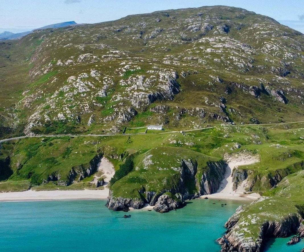 Ceannabeinne Beach sprawls out in front of Ceannabeinne Cottage, one of Scotland's best luxury hotels, cottages and cabins