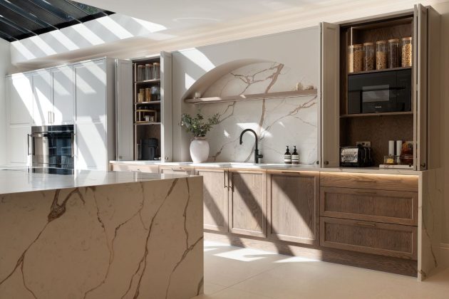 marble kitchen with black taps, marble splashback, white floor and walnut teak sunken shelves