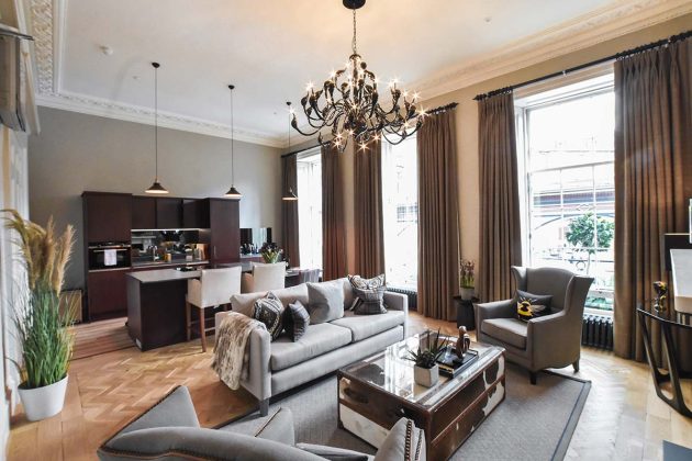 luxury hotel room with velour sofas and chandeliers