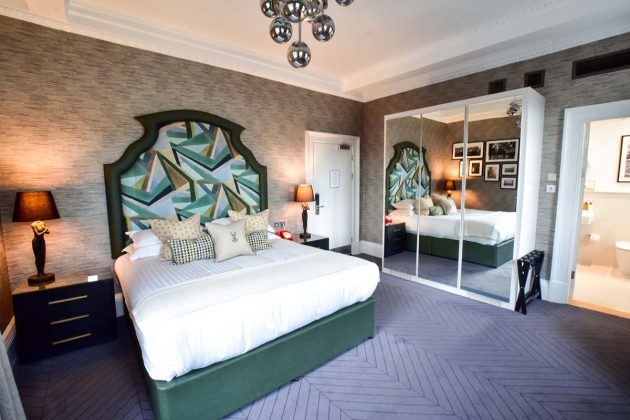 wacky bed headboard on a green bed with a purple carpet and statement pendant lights