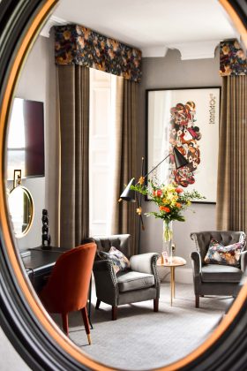 a mirror image of orange chairs in the meadowpark hotel