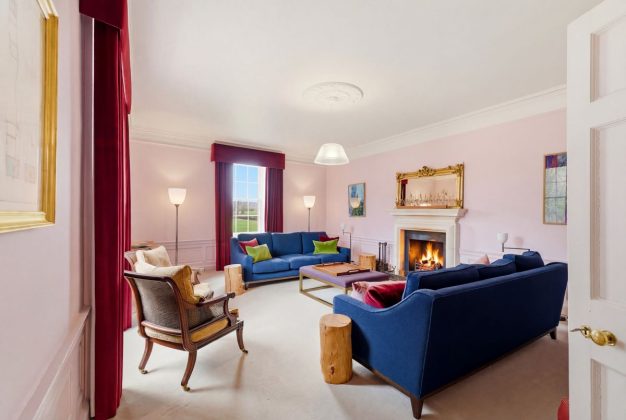 quirky colourful living room with a fireplace at Papple in Scotland