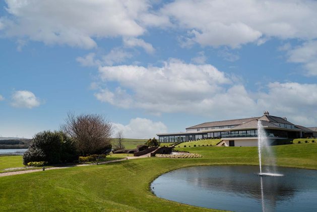 the exterior with sweeping greenery at Lochside House Hotel Spa & Lodges in Scotland