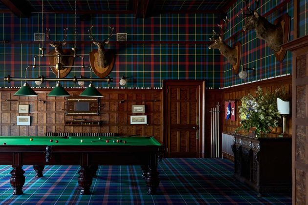 dornoch station hotel games room with blue tartan carpets and blue tartan wallpaper and a pool table, one of Scotland's best luxury hotels