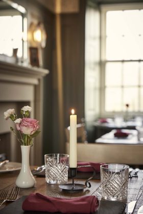 restaurant with candlesticks and a traditional fireplace