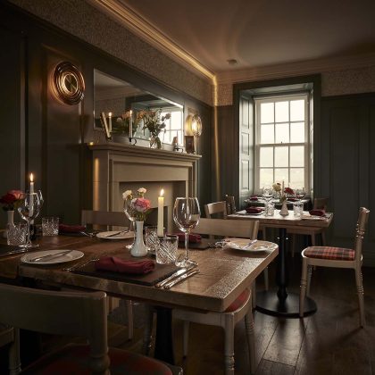 restaurant with oak tables and roses