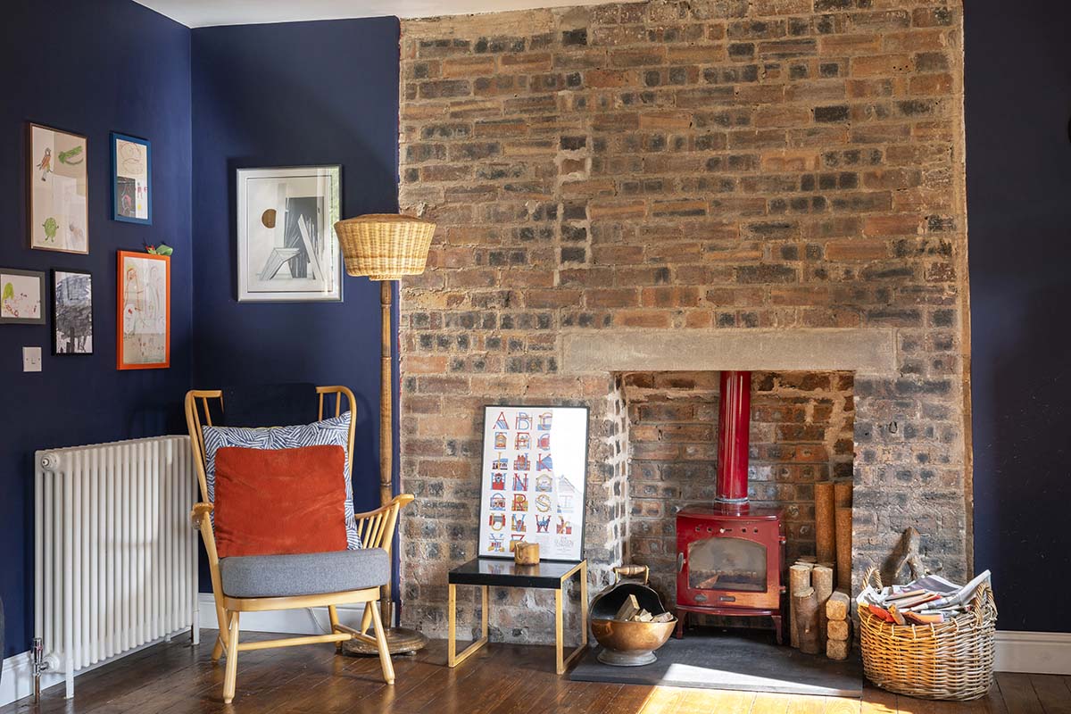 scotland's home of the year 2026 winners interview with opinions from anna campbell jones, danny campbell and banjo beale; blue living room with rust orange cushions and white ceiling and colour drenched walls