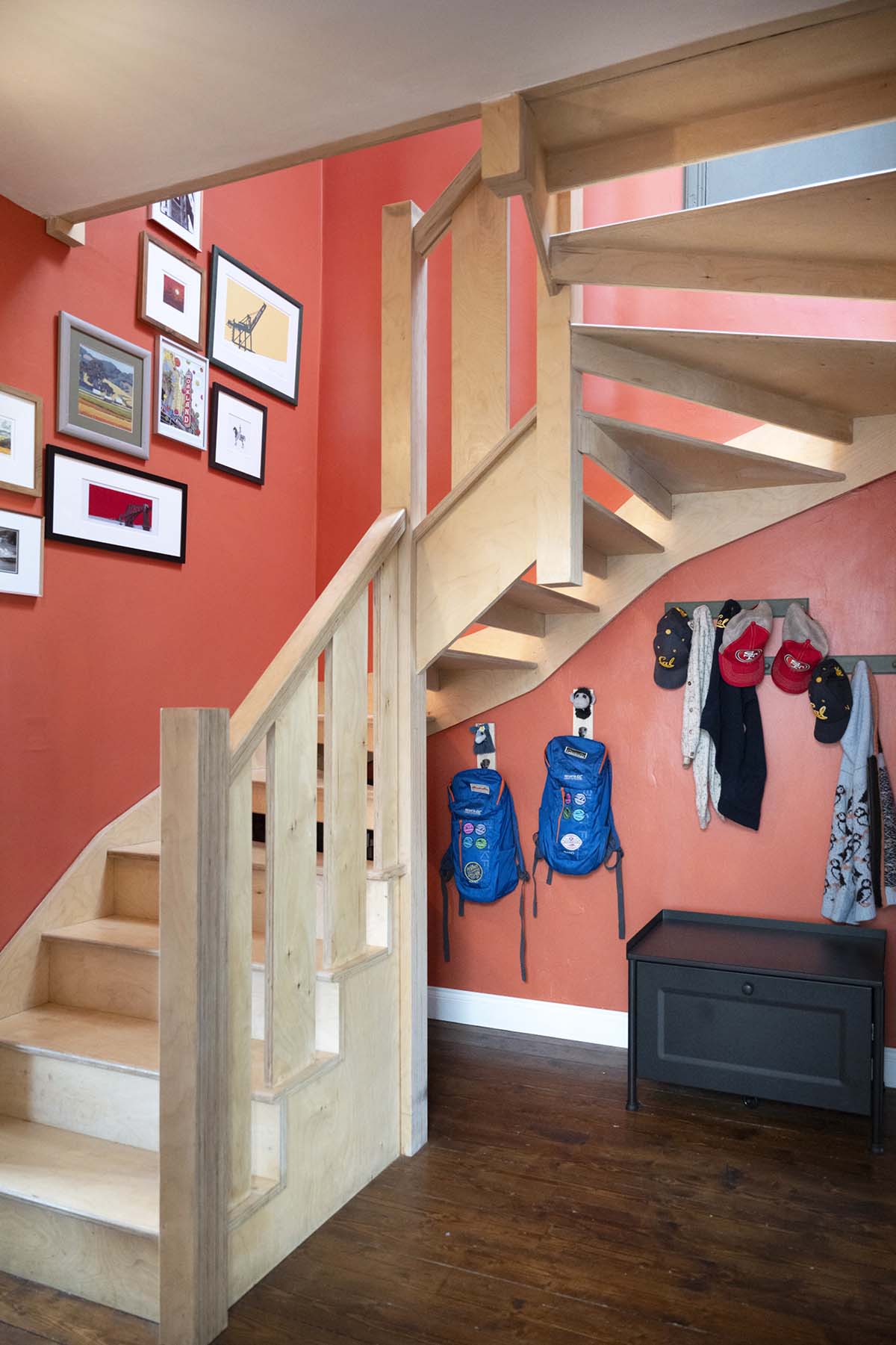 scotland's home of the year 2026 winners interview with opinions from anna campbell jones, danny campbell and banjo beale; red hallway and entryway with exposed stone walls and a handcrafted winding oak staircase