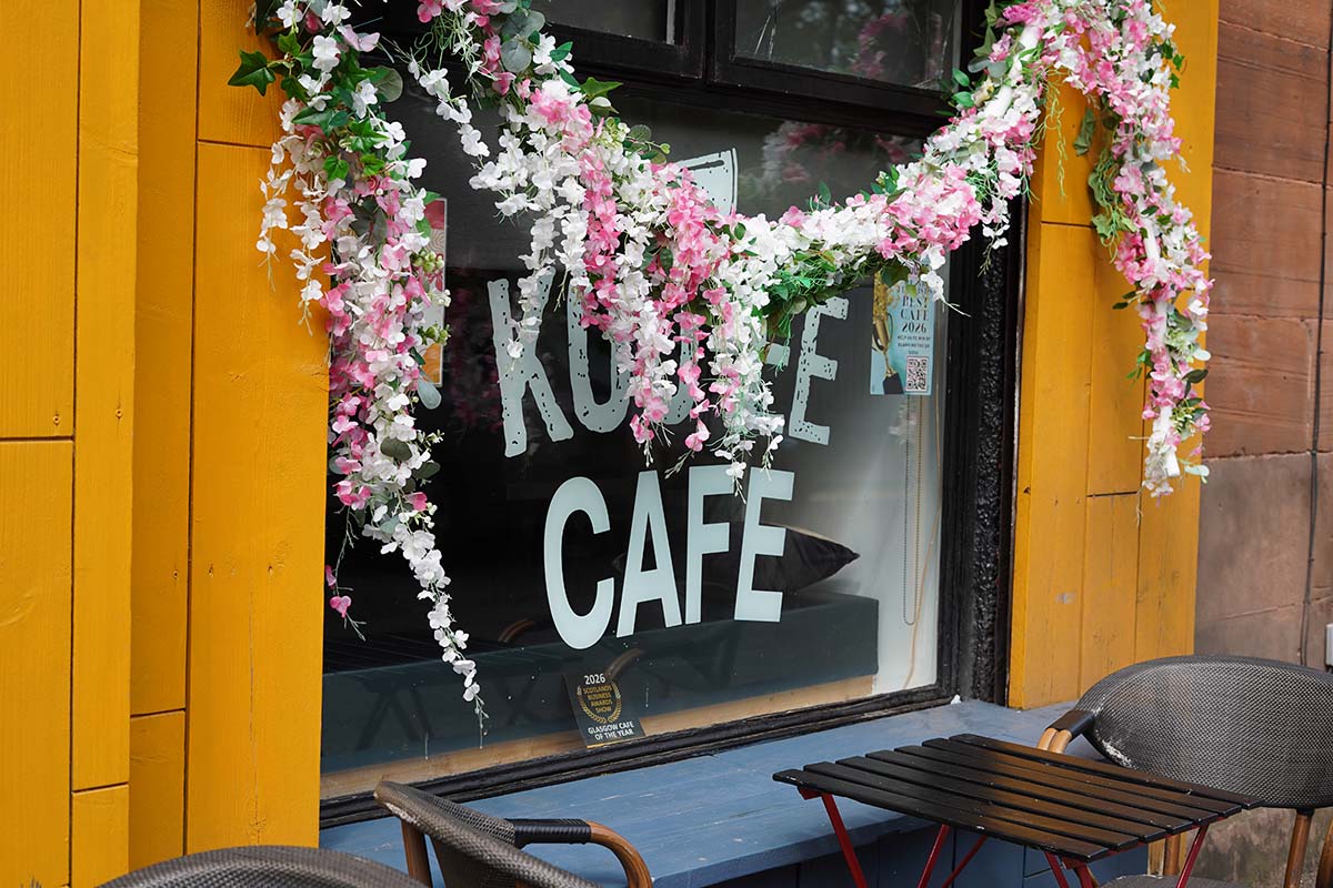koo-ee cafe in glasgow frontage with blossom and orange walls