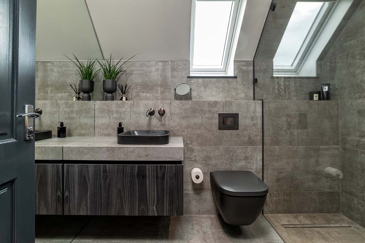 black and grey bathroom with slate tiling and a black toilet