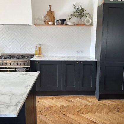 black kitchen with herringbone floor; Bois de Vie Alaska is a premium, European oak engineered wood flooring line offered by The Wooden Floor Store
