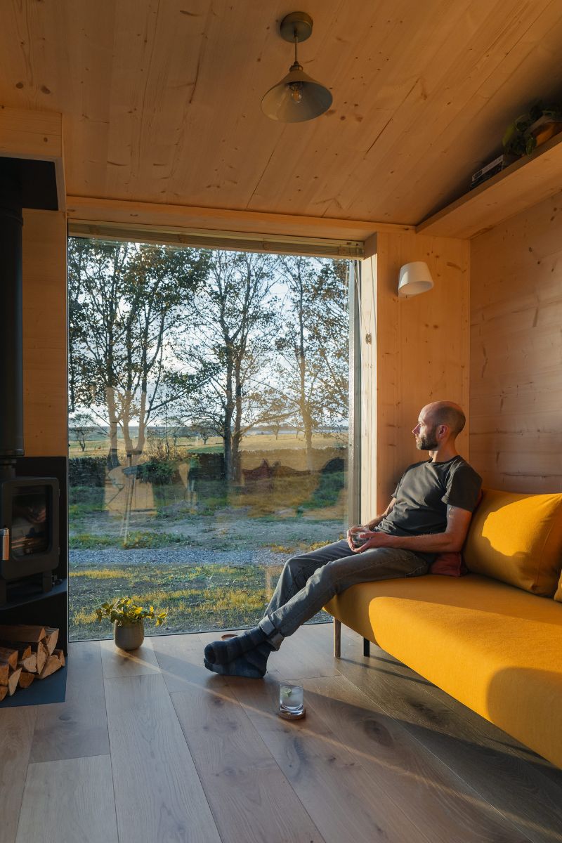 Del looks out huge windows at home