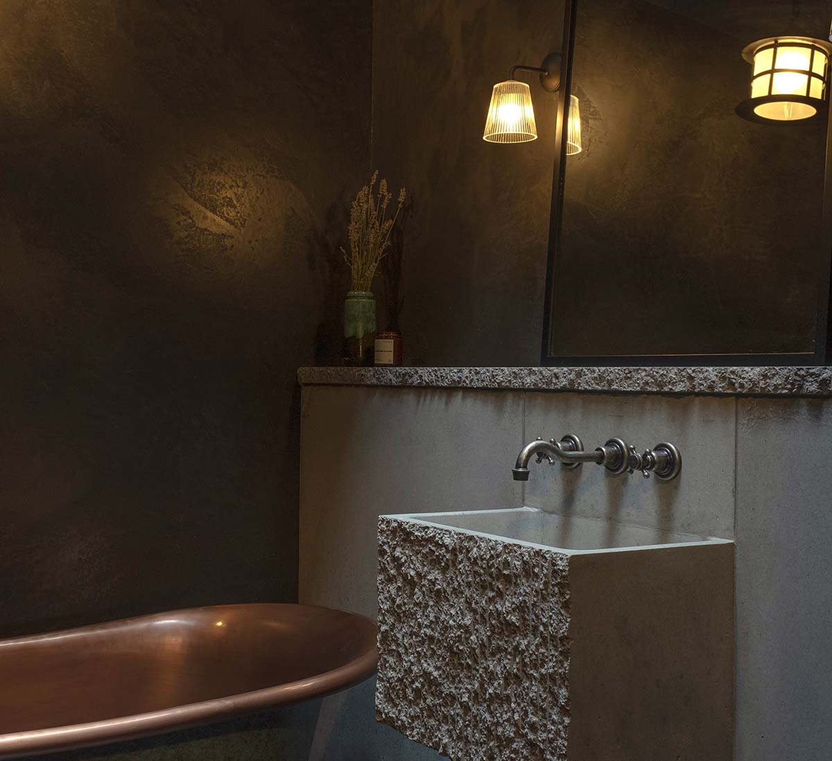 Copper bath and concrete surfacing in a moody bathroom project by Scottish interior designer Braw House