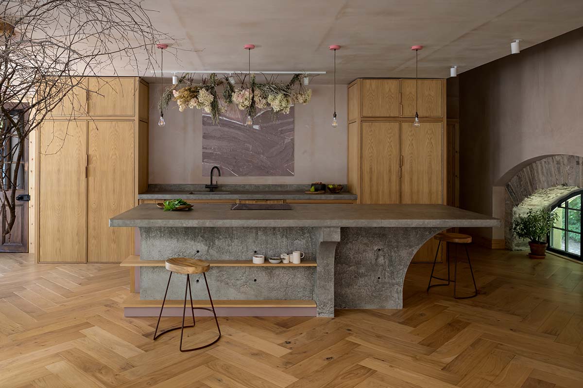 nicholas denney studio designs the concrete structures in this oak panelled kitchen with herringbone flooring and slate offsets