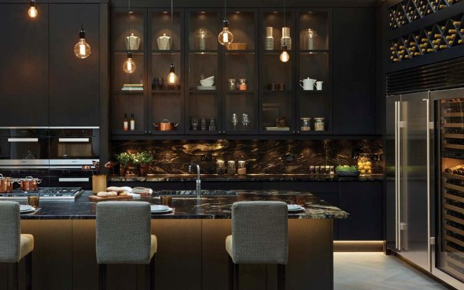 black moody kitchen with wine fridge and wall to wall drinks shelves
