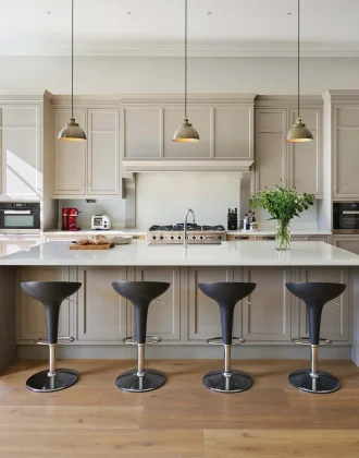 white and black kitchen with pops of colour in houseplants and lighting