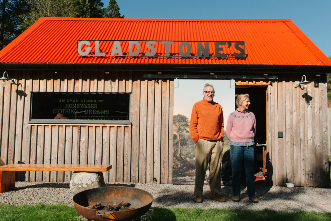Charlie and Caroline stand outside their shop