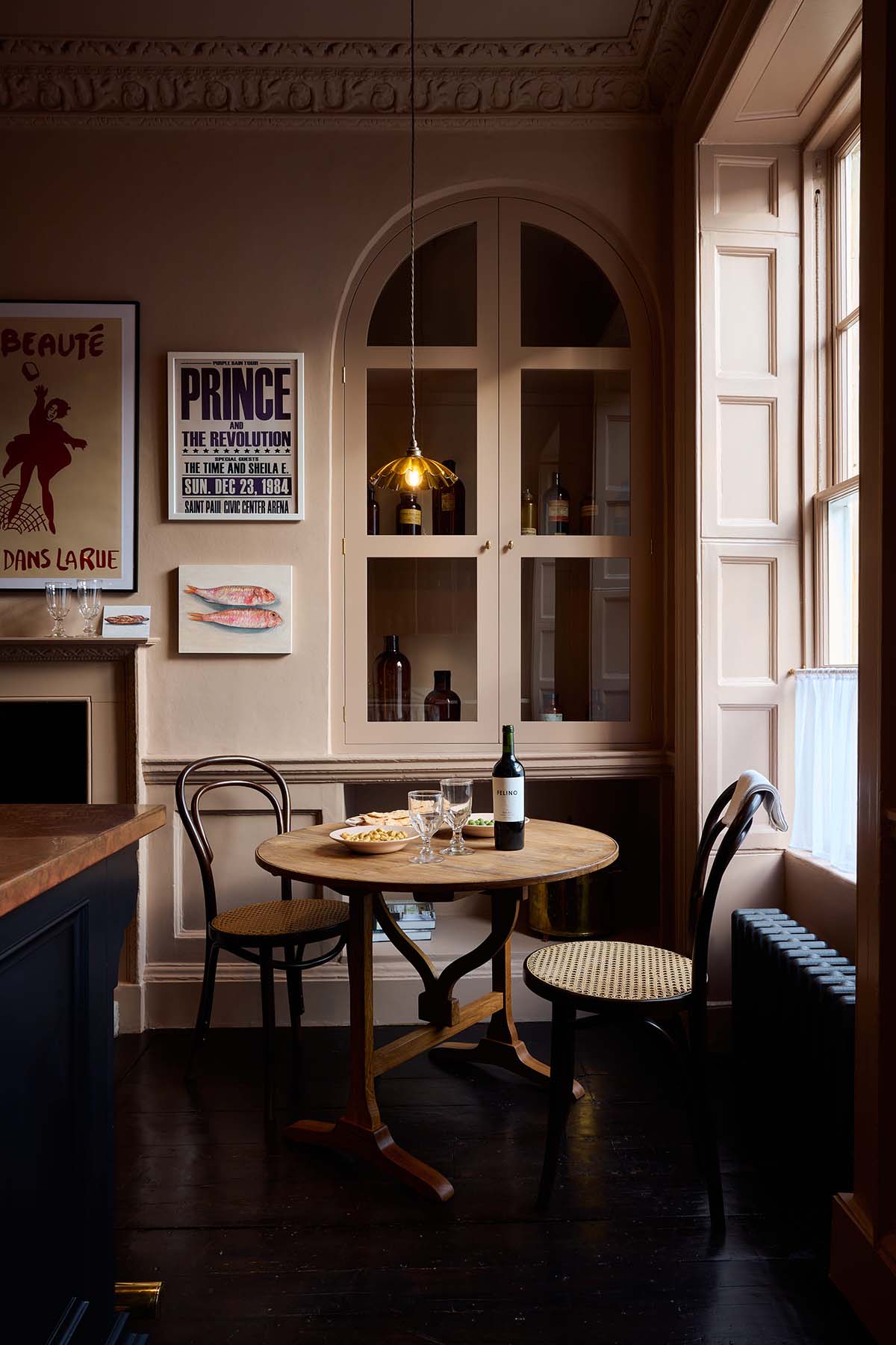 deVOL showroom in Bath; low lighting in a pink kitchen
