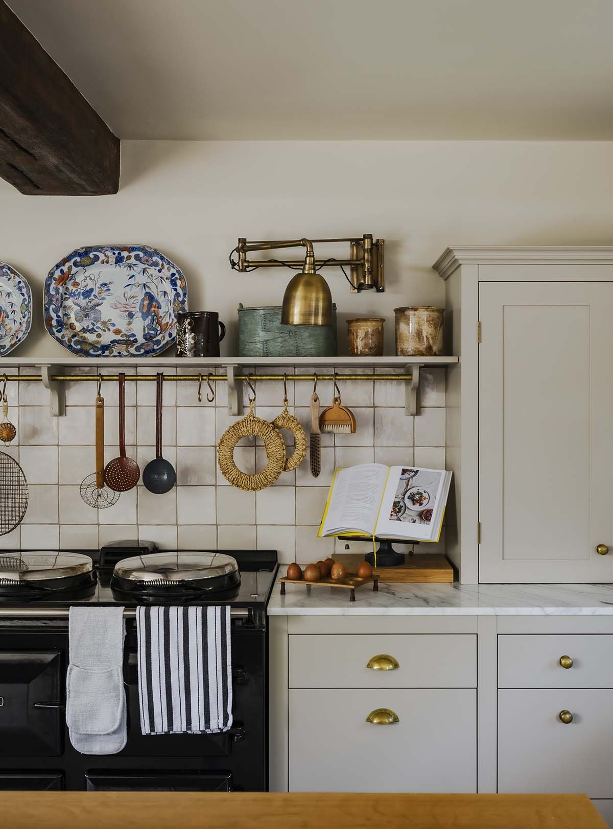 bistro kitchen design with light wood worktops and open shelves to reveal brass cookware